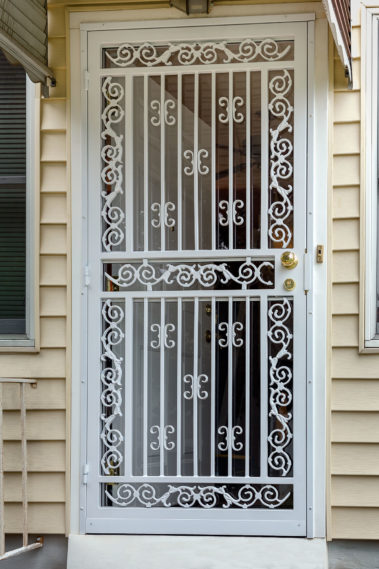 mediterranean white security door on beige house