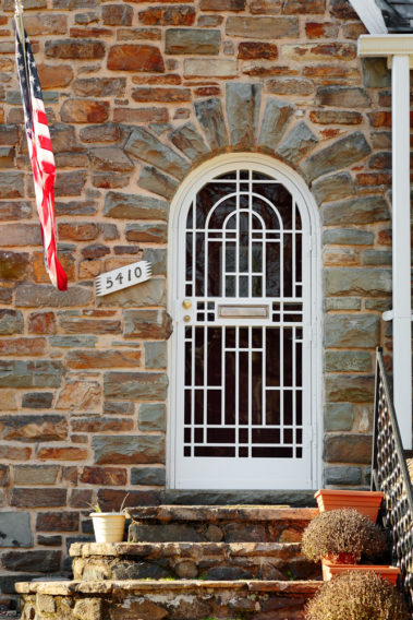 cathedral top security door on stone house