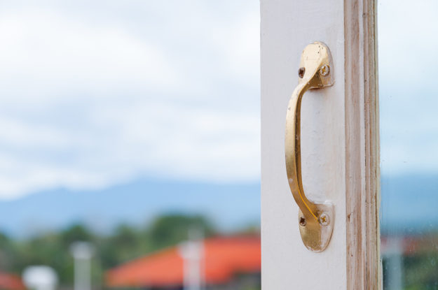 Golden Stainless steel vintage style handle on painted wooden wh steel vs fiberglass doors, door handle close up
