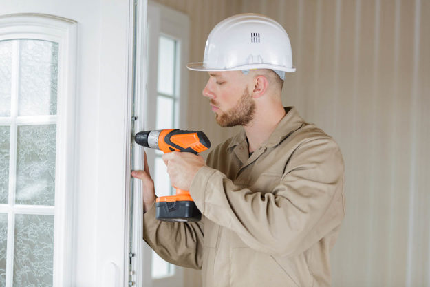 Do I Need a New Front Door Installed_ worker drilling