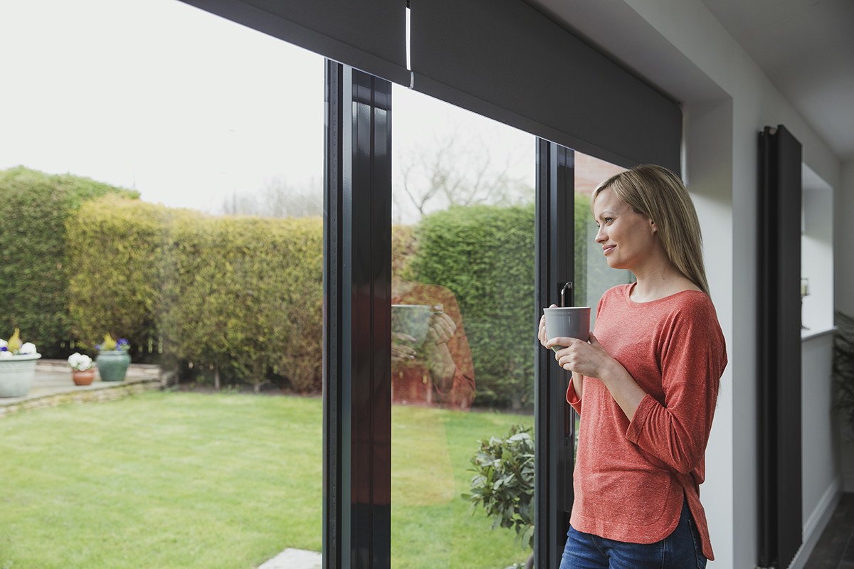 a woman experiencing the benefits of patio doors