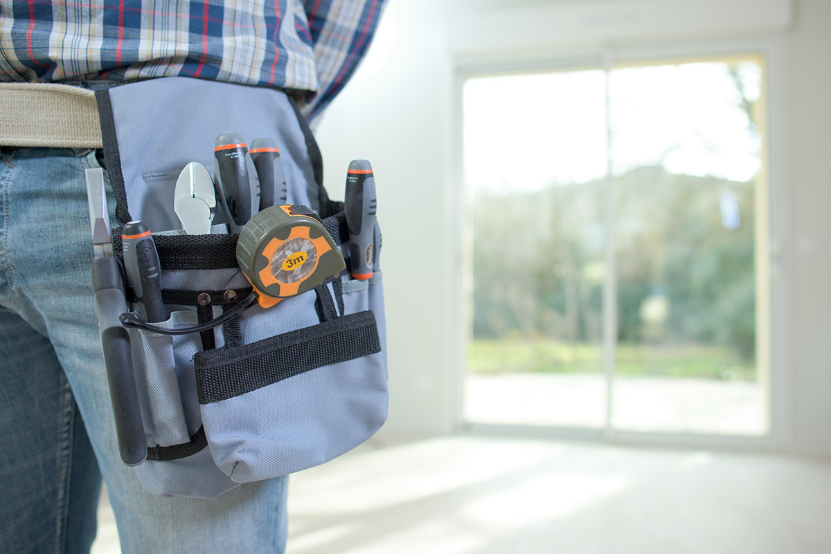 Best Energy Efficient Doors (1) man installs energy efficient doors