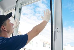 man installs a window for master seal