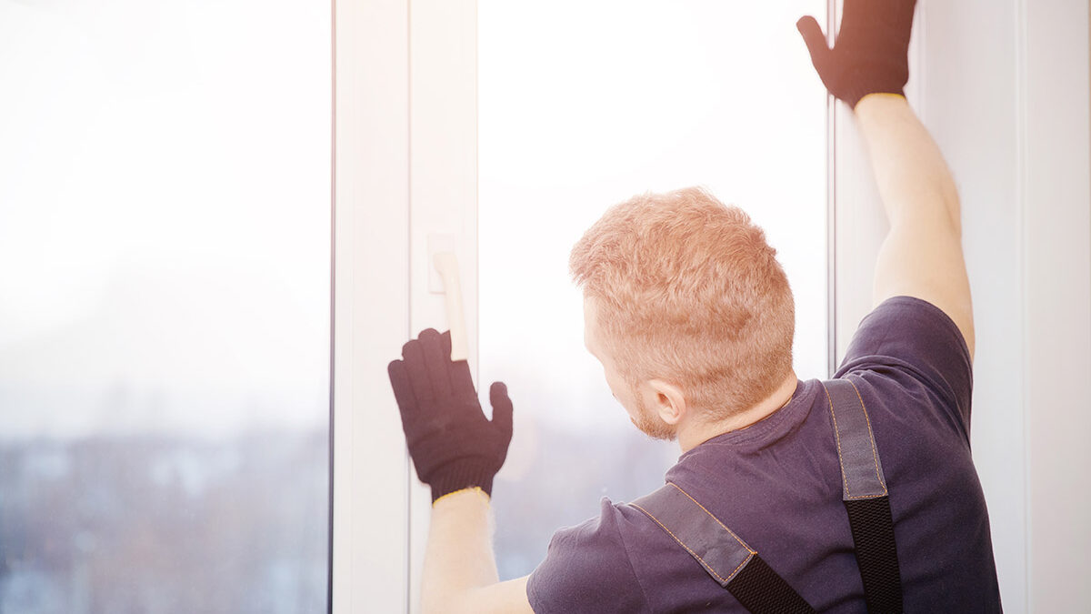 man installs a replacement window
