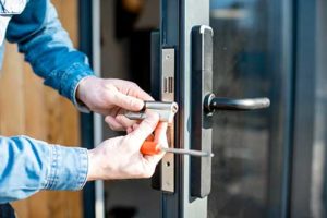 man installs a security door 