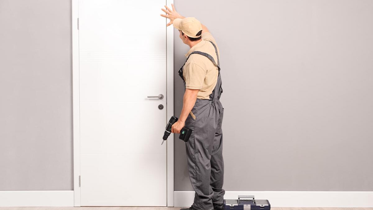 man installs a fiberglass door