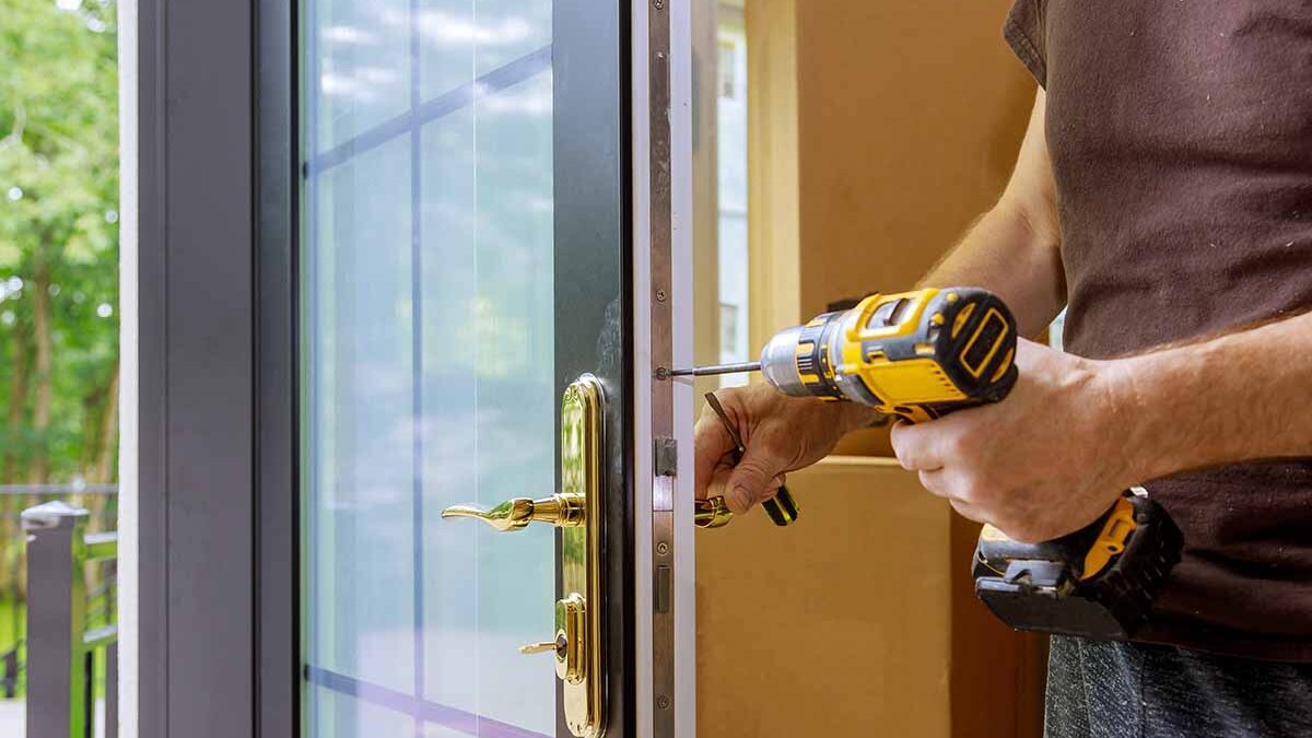 man replaces patio doors