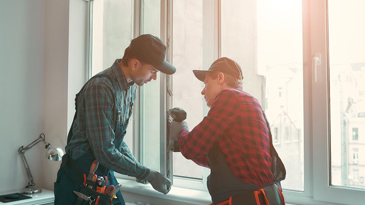 two men installing a window while discussing window terminology