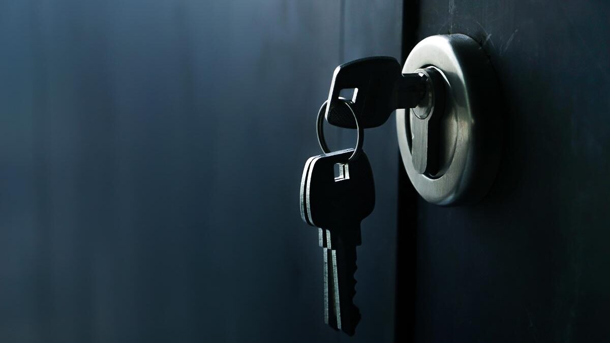 A key sits in the lock of a security door.