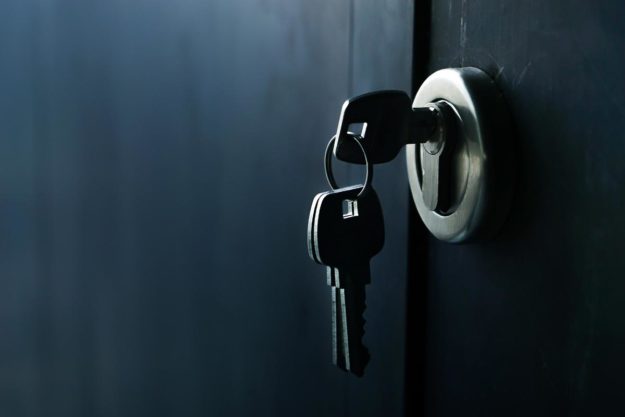 A key sits in the lock of a security door.
