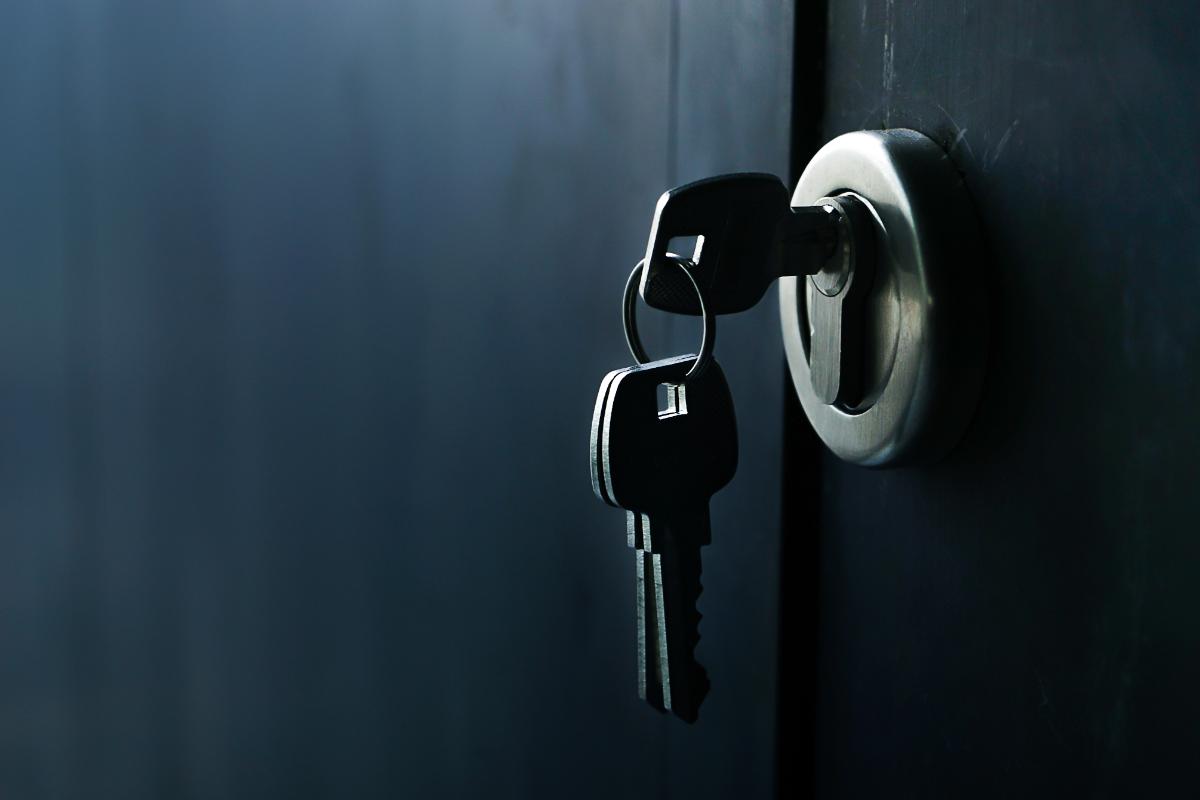 3 Ways Safety Doors Improve Home Security A key sits in the lock of a security door.