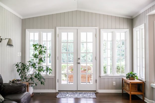 DIY Draft Stoppers for Doors to Save on Your Energy Bill A beautiful and airy living room space with wide windows and natural light is secured from drafts by DIY draft stoppers for doors