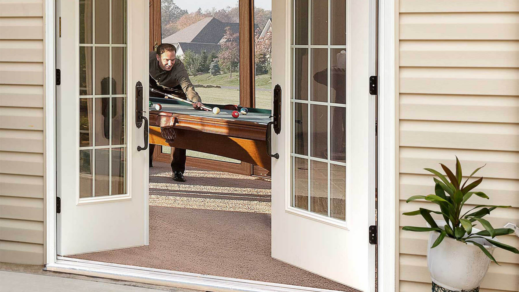 A french door connecting a patio to a game room