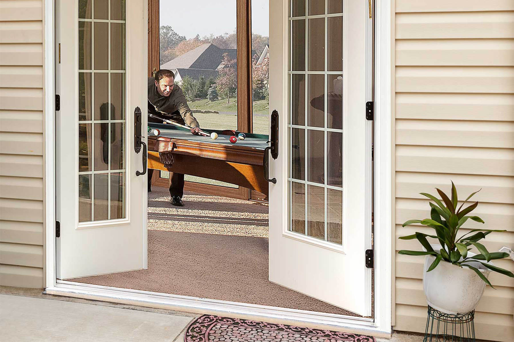 Hinged Patio Door vs. French Door What’s the Difference MasterSeal Image A french door connecting a patio to a game room