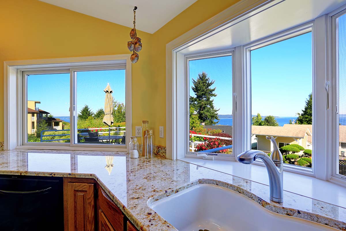 Pros and Cons of Garden Window Vs Bay Window a big set of windows overlooking a beautiful bay to demonstrate garden window vs bay window