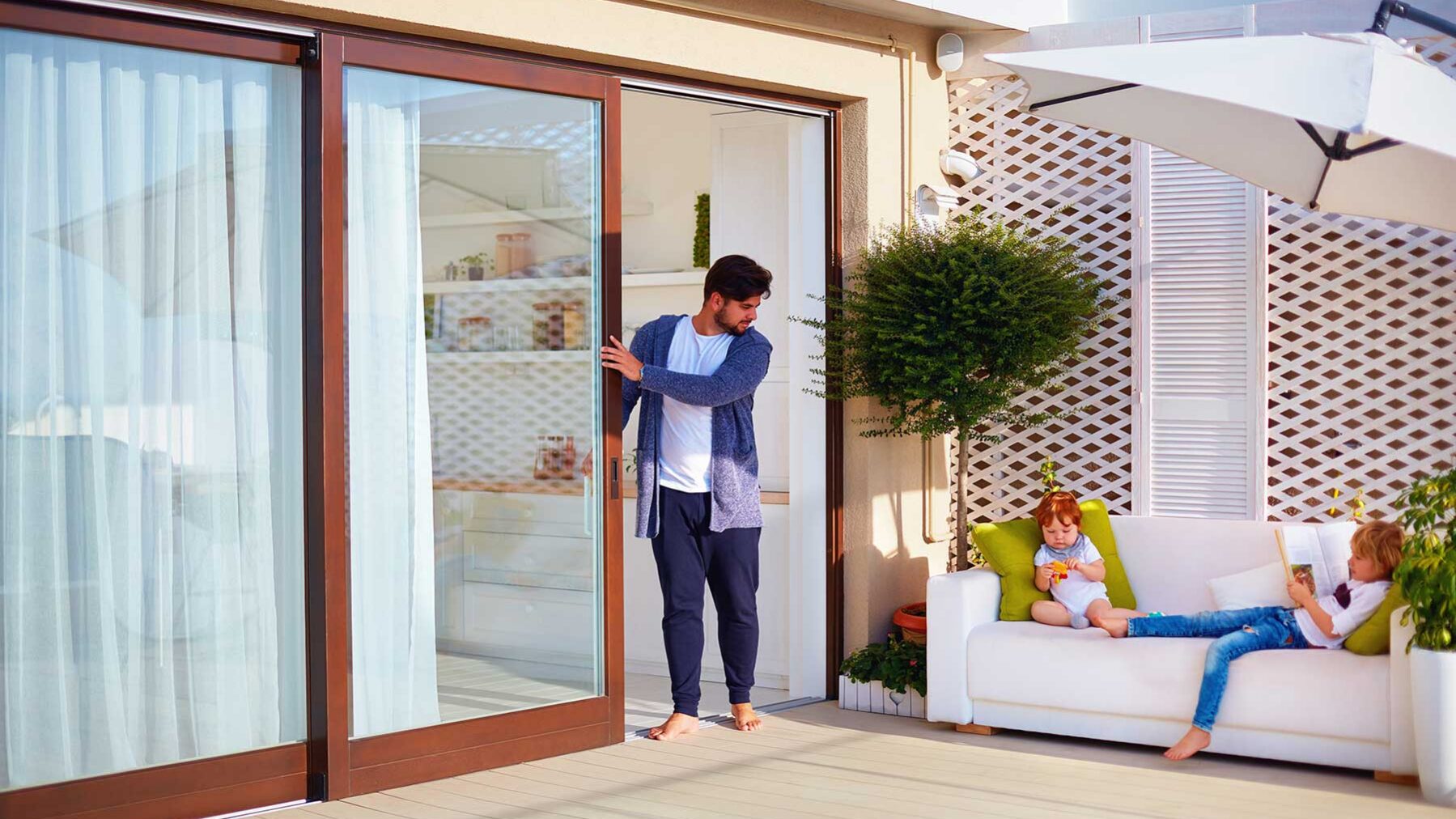 a man is happy he chose a sliding patio door for his home
