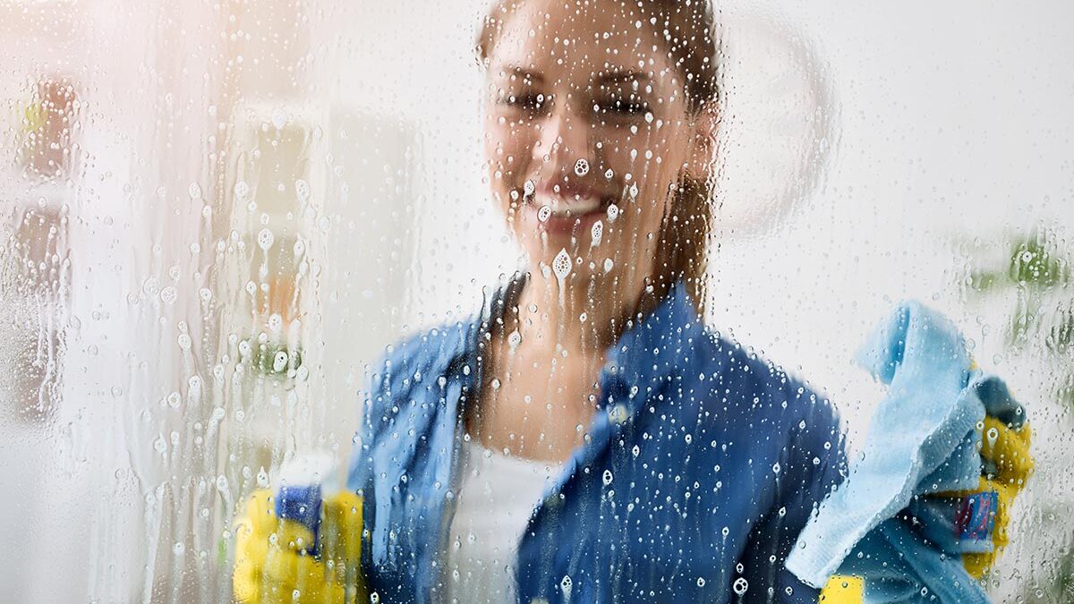 a woman is happy with the effectiveness of a homemade window cleaner