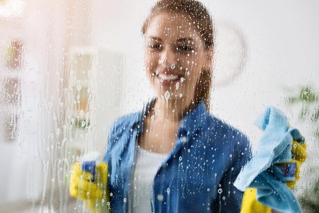 3 Best Homemade Window Cleaners a woman is happy with the effectiveness of a homemade window cleaner