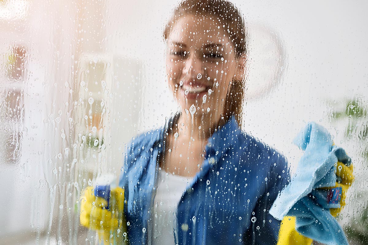 3 Best Homemade Window Cleaners a woman is happy with the effectiveness of a homemade window cleaner
