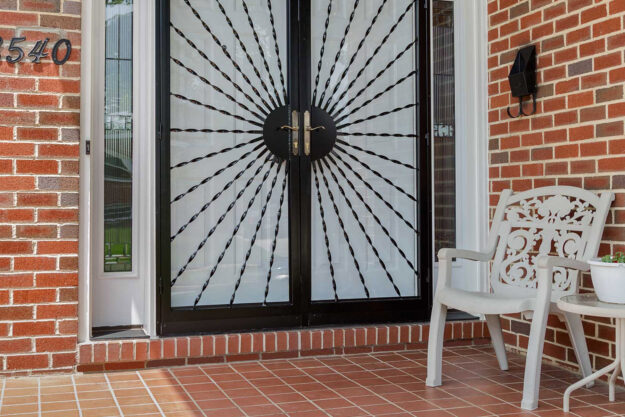 Double front door with decorative storm door