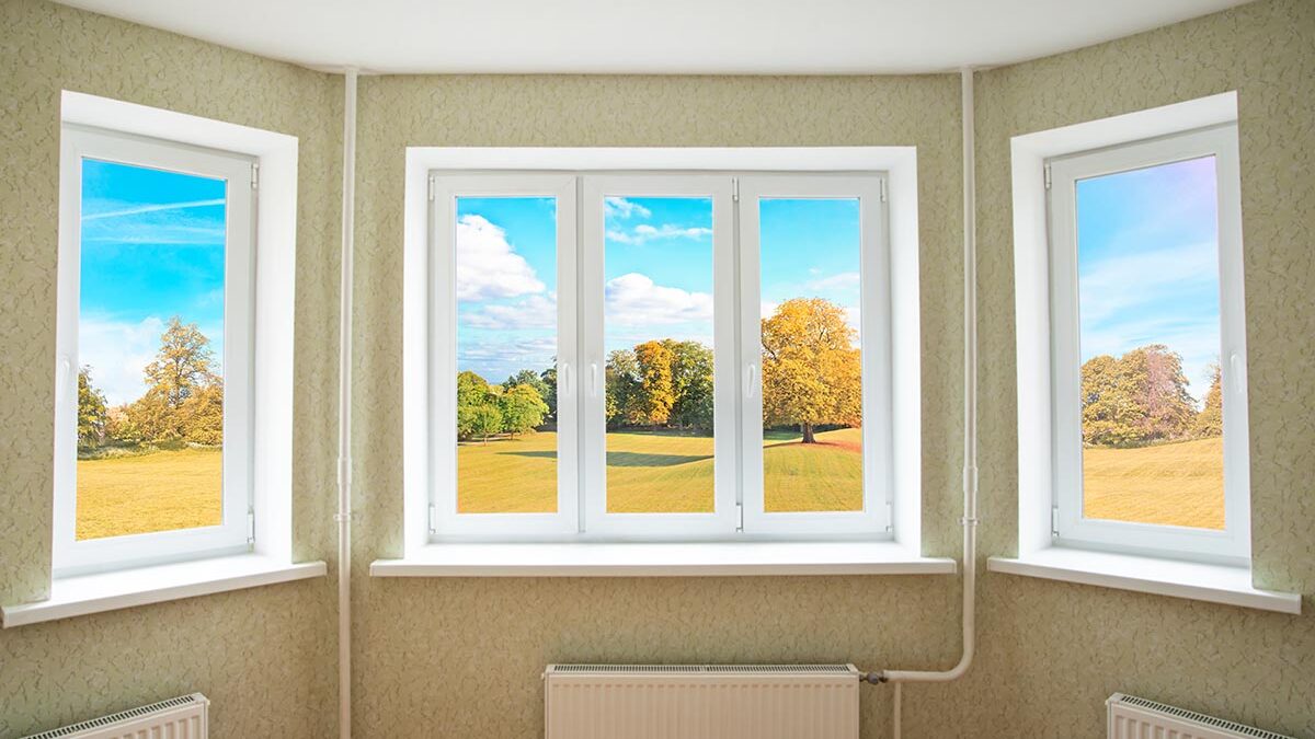 a view of autumn scenery from inside through a bay window