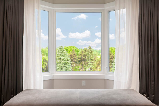 How to Dress a Bay Window With and Without Curtains a homeowner has dressed their bay window with flowy curtains