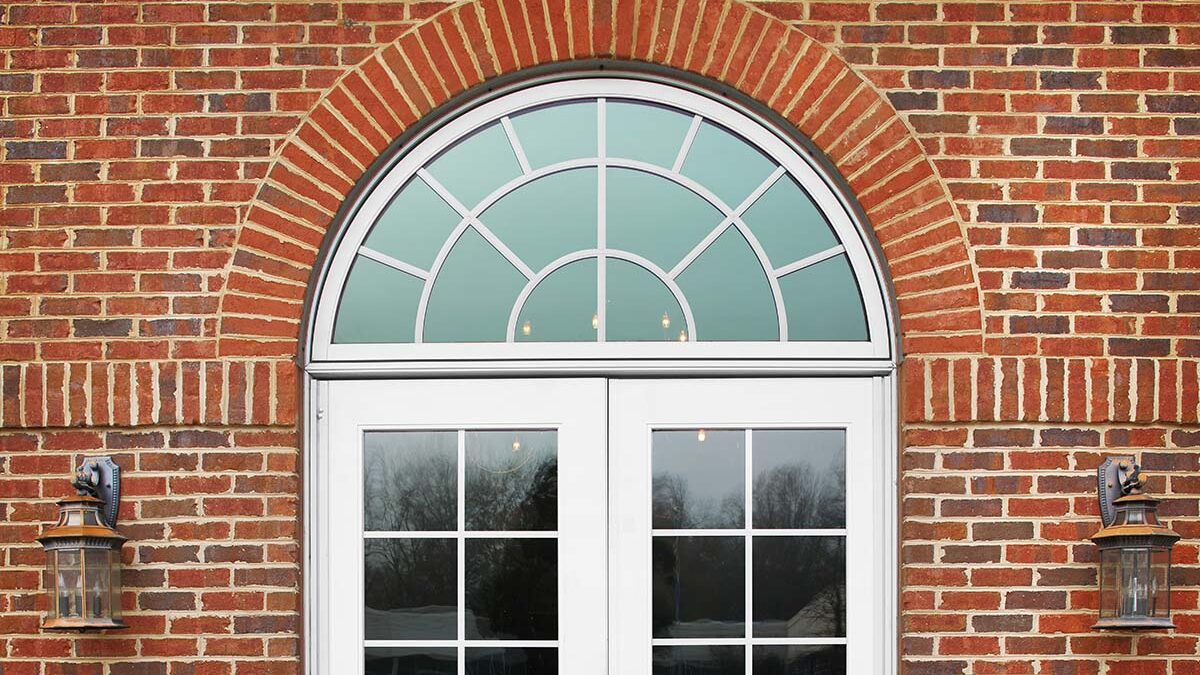 a newly installed half circle window above an entryway