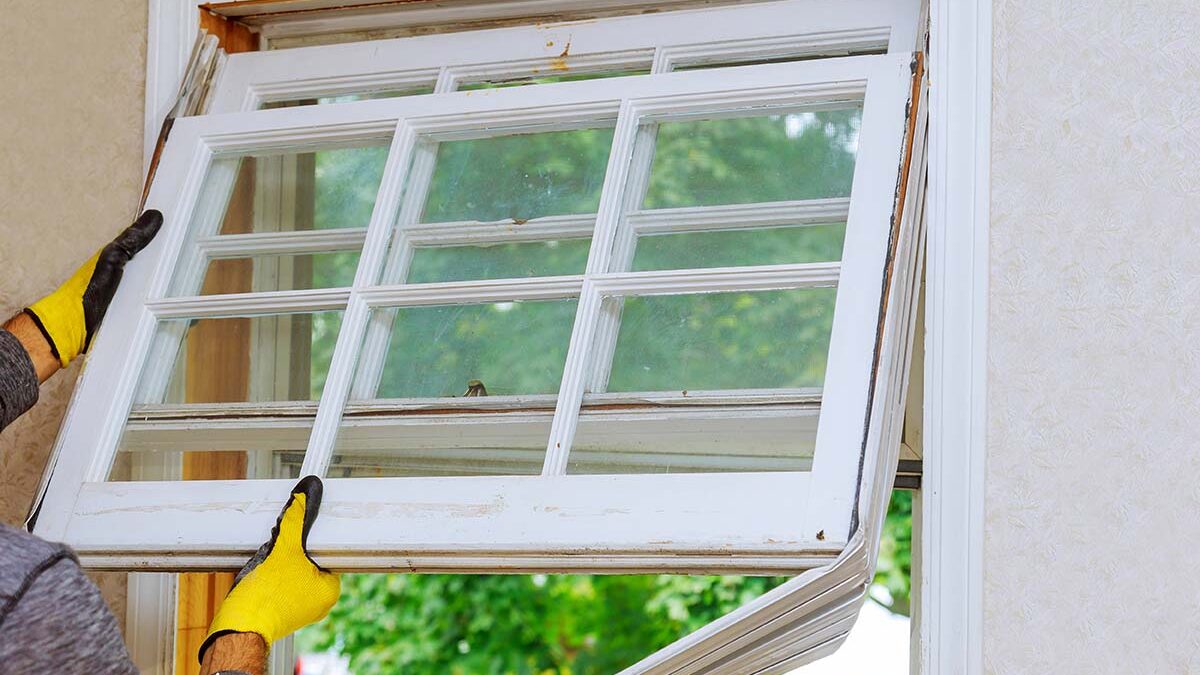 professionals install new windows in a house
