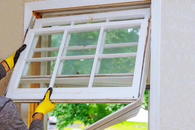 Replacing Windows Before Selling a House- Is It Worth the Investment professionals install new windows in a house
