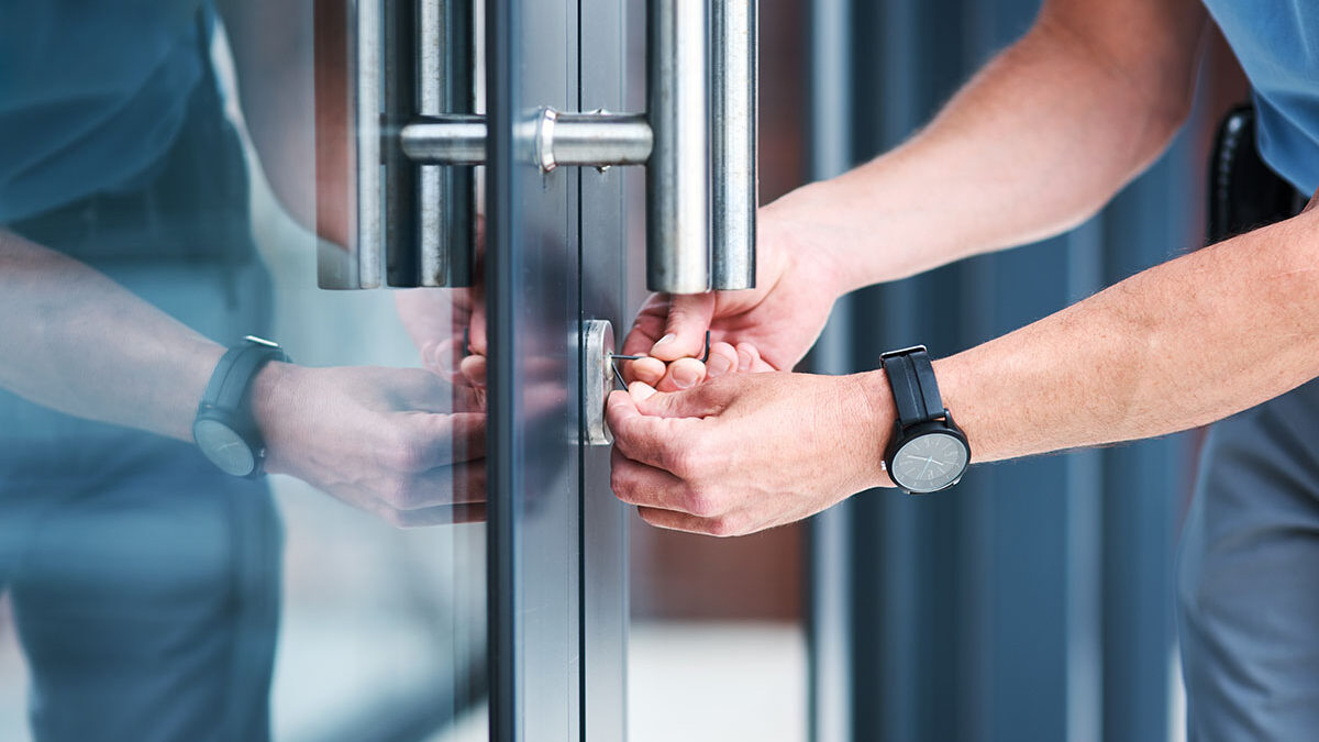 a man locks up a commercial door
