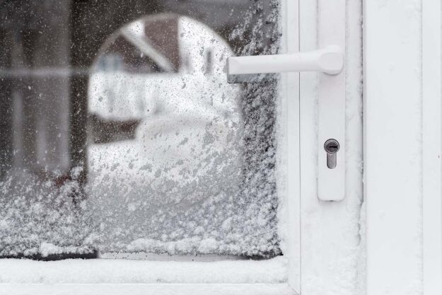 How to Weather Seal Your Front Door a weather sealed front and storm door in the snow