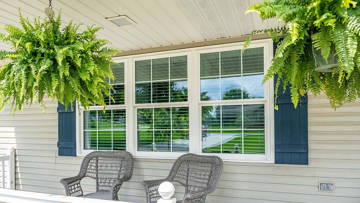 blue exterior window shutters add a touch of color to a home