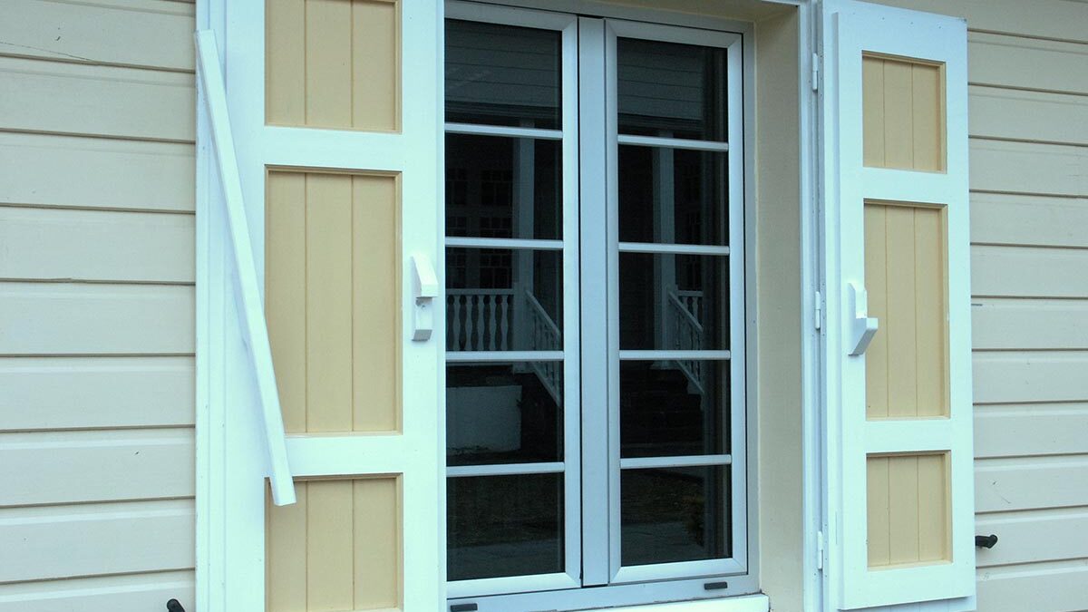 newly installed tinted windows with shutters on the side of a house