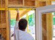 Man measuring for the perfect fit of a storm door