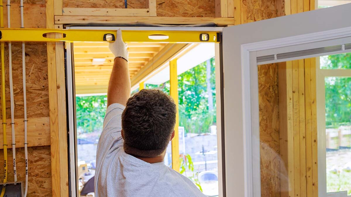 Man measuring for the perfect fit of a storm door