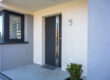 a steel entry door on the front facade of a home
