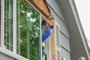 Person installing window on house