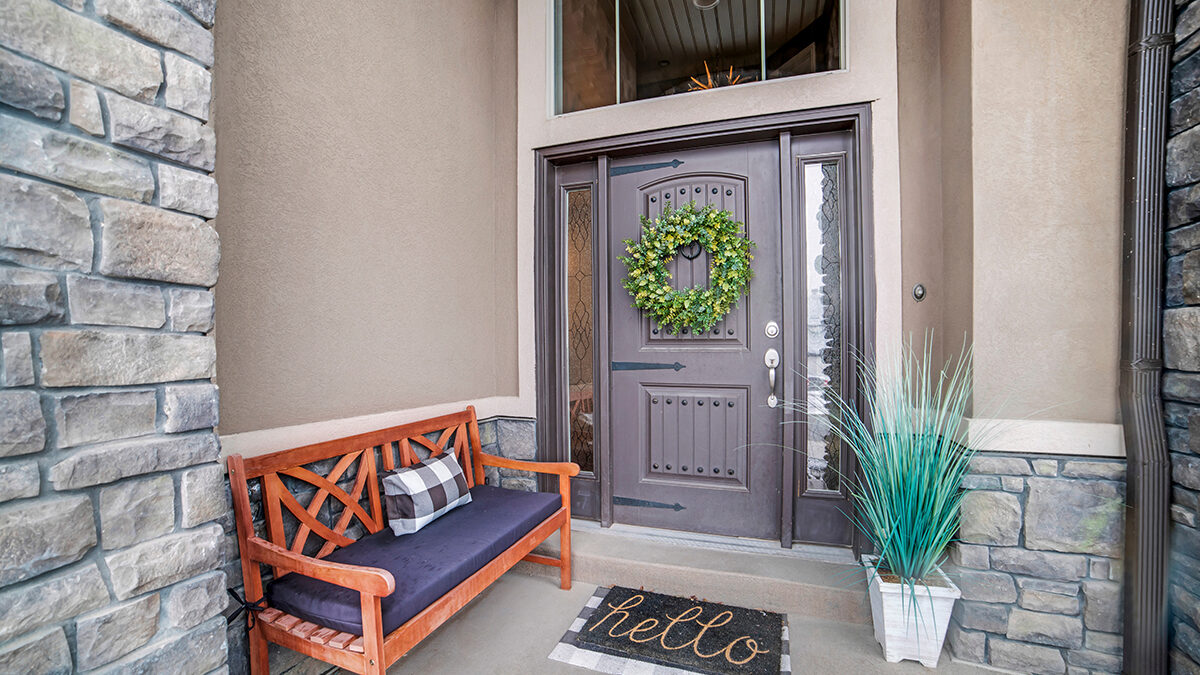 Beautiful home entrance with gray door sidelights and huge transom window gray front door with sidelights on a tan house