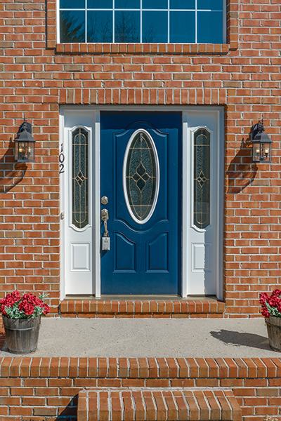 blue fiberglass door on a brick house with sidelights