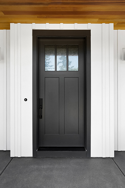 black front door on a white exterior without sidelights